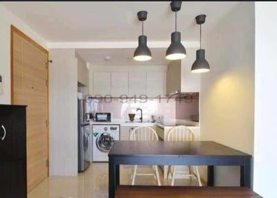 Modern kitchen with integrated dining area and ample natural light