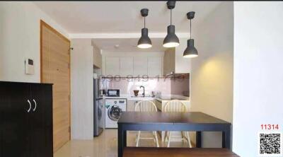 Modern kitchen with integrated dining area and ample natural light