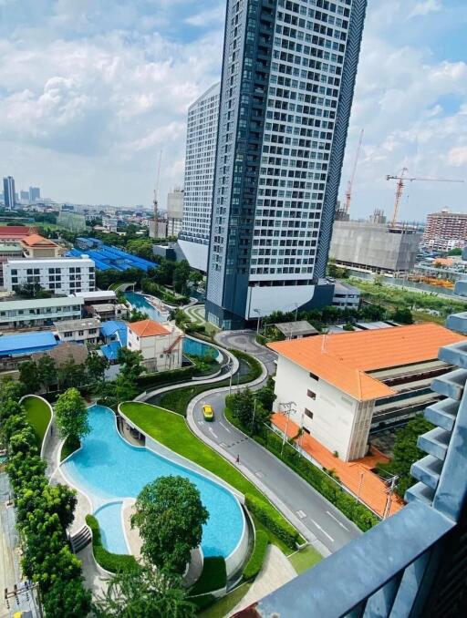 High-rise residential building with swimming pool and garden view