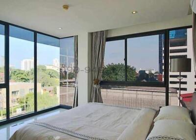 Modern bedroom with large windows and urban view