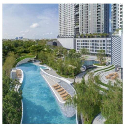 Luxurious outdoor swimming pool area with lush landscaping in a modern residential development