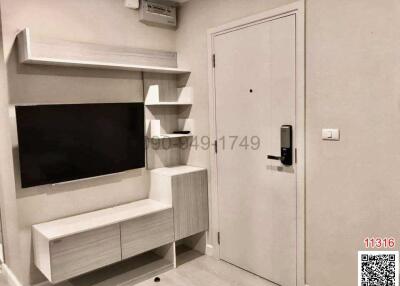Modern living room interior with flat-screen TV and stylish shelving unit