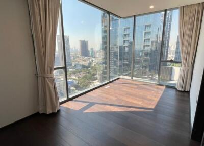 Spacious bedroom with large windows and city view