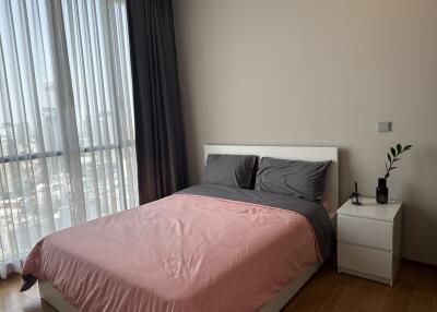 Modern bedroom with large window and city view