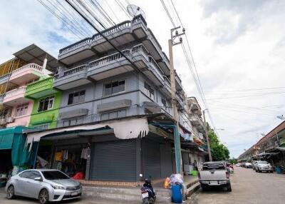 Multi-story residential building with commercial space on the ground floor