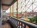 Spacious balcony with geometric railing and urban view