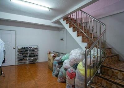 Basement interior with staircase and storage items