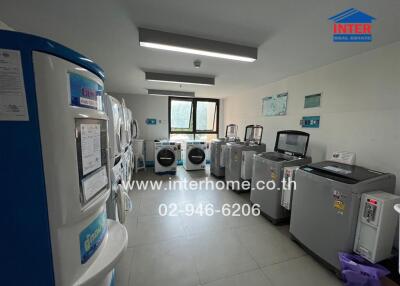 Modern laundry room with multiple washing machines and a bright window