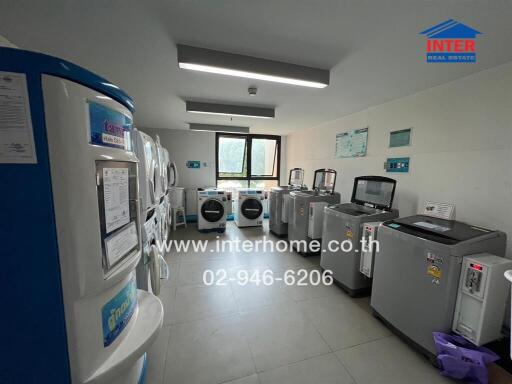 Modern laundry room with multiple washing machines and a bright window