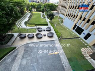 Outdoor community space with seating and lush garden view