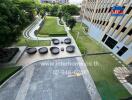 Outdoor community space with seating and lush garden view