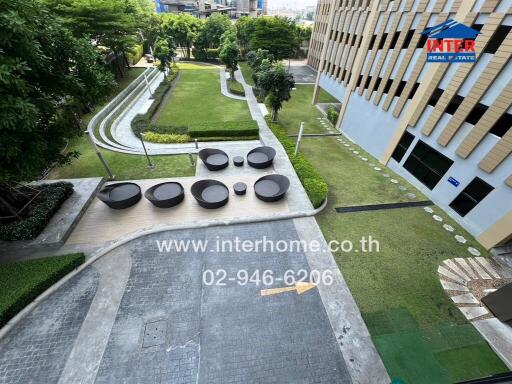 Outdoor community space with seating and lush garden view