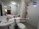 Modern bathroom with white fixtures and tiled walls