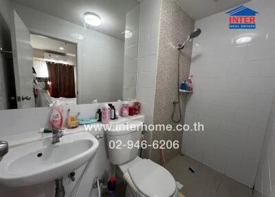 Modern bathroom with white fixtures and tiled walls