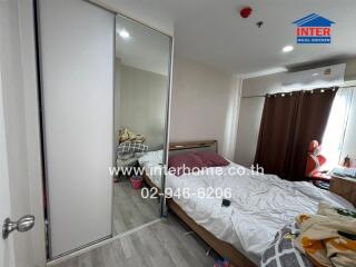 Spacious bedroom with large bed and mirrored wardrobe