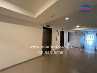 Brightly lit building hallway with closed elevator doors