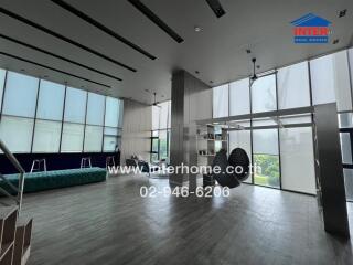 Spacious modern living room with large windows and panoramic city views