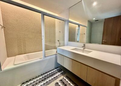 Modern bathroom with bathtub and large mirror