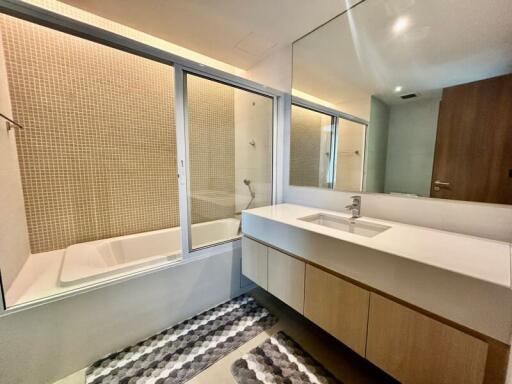 Modern bathroom with bathtub and large mirror