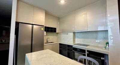 Modern kitchen with white cabinetry and marble countertops