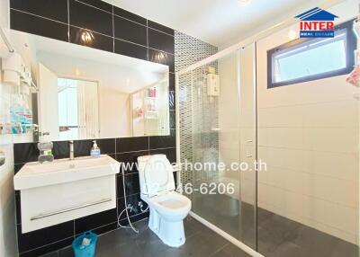 Modern bathroom with shower and large mirror