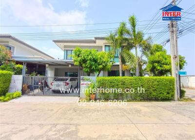 Modern two-story home with a landscaped front yard and secure gate