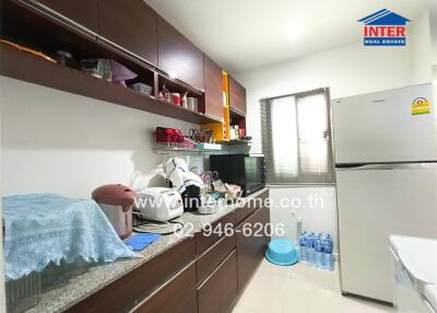 Modern kitchen with ample shelving and essential appliances