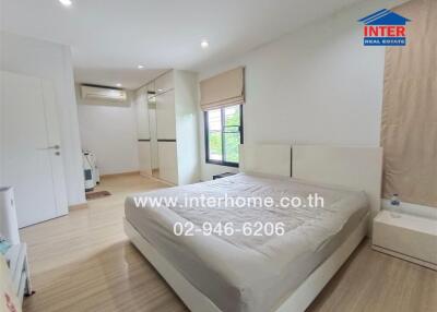 Spacious bedroom with modern furnishings and ample natural light