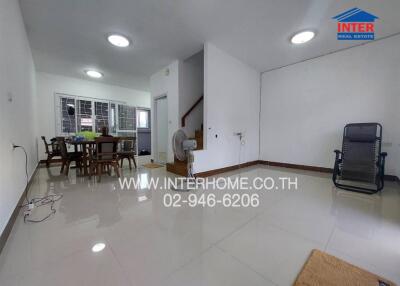 Spacious and well-lit living room with dining area