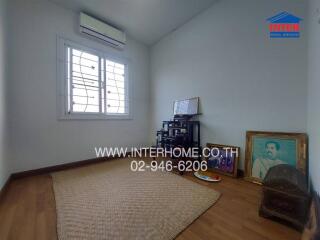 Spacious bedroom with air conditioning unit and natural light