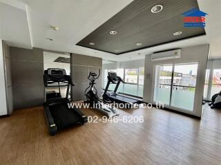 Modern home gym with fitness equipment in a well-lit room