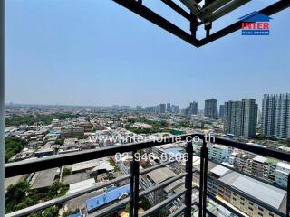 Expansive city view from high-rise balcony with safety railings