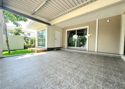 Spacious covered patio with elegant floor tiling and ample lighting