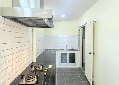 Modern kitchen with stainless steel appliances and white subway tile backsplash