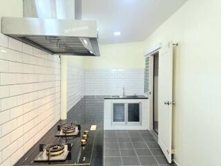 Modern kitchen with stainless steel appliances and white subway tile backsplash