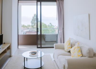 Modern living room with sliding glass doors leading to a balcony