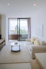 Modern living room with sliding glass doors leading to a balcony