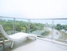 Spacious balcony with panoramic views and modern lounge chair