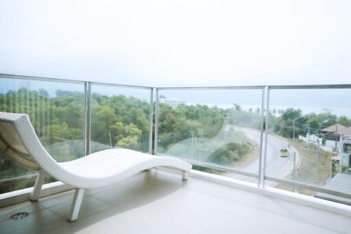 Spacious balcony with panoramic views and modern lounge chair