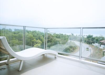 Spacious balcony with panoramic views and modern lounge chair