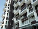 Modern residential apartment building with balconies and pool