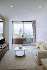 Modern living room with balcony access and ample natural light