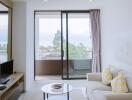 Modern living room with balcony access and ample natural light