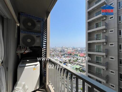Urban apartment balcony overlooking the cityscape with appliances