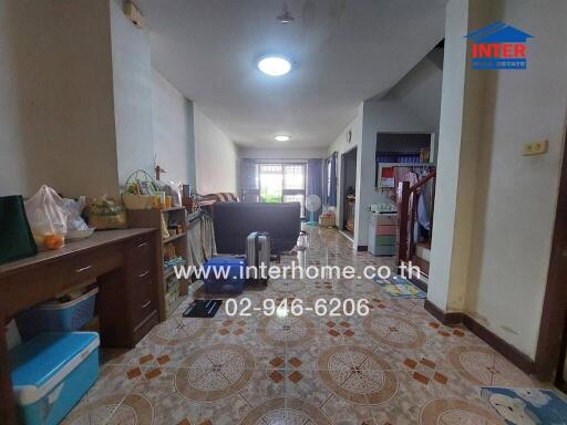 Spacious living room with ceramic tiled flooring and natural lighting