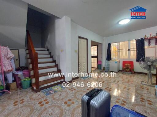 Spacious living room with staircase and large window