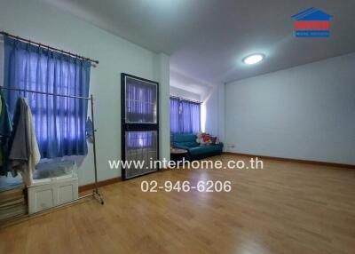 Spacious living room with parquet flooring and large windows