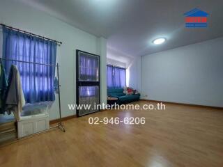 Spacious living room with parquet flooring and large windows