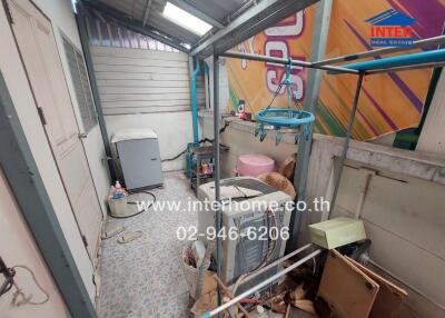 Cluttered utility room with various objects and appliances