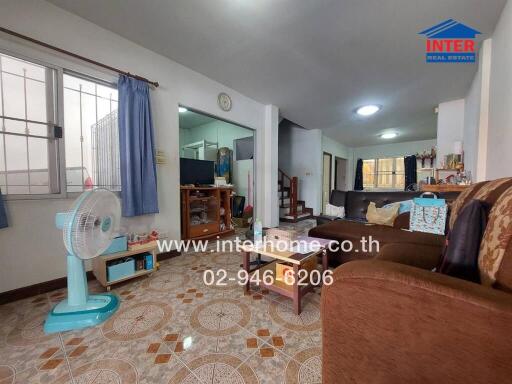 Spacious living room with tiled flooring and modern furnishing